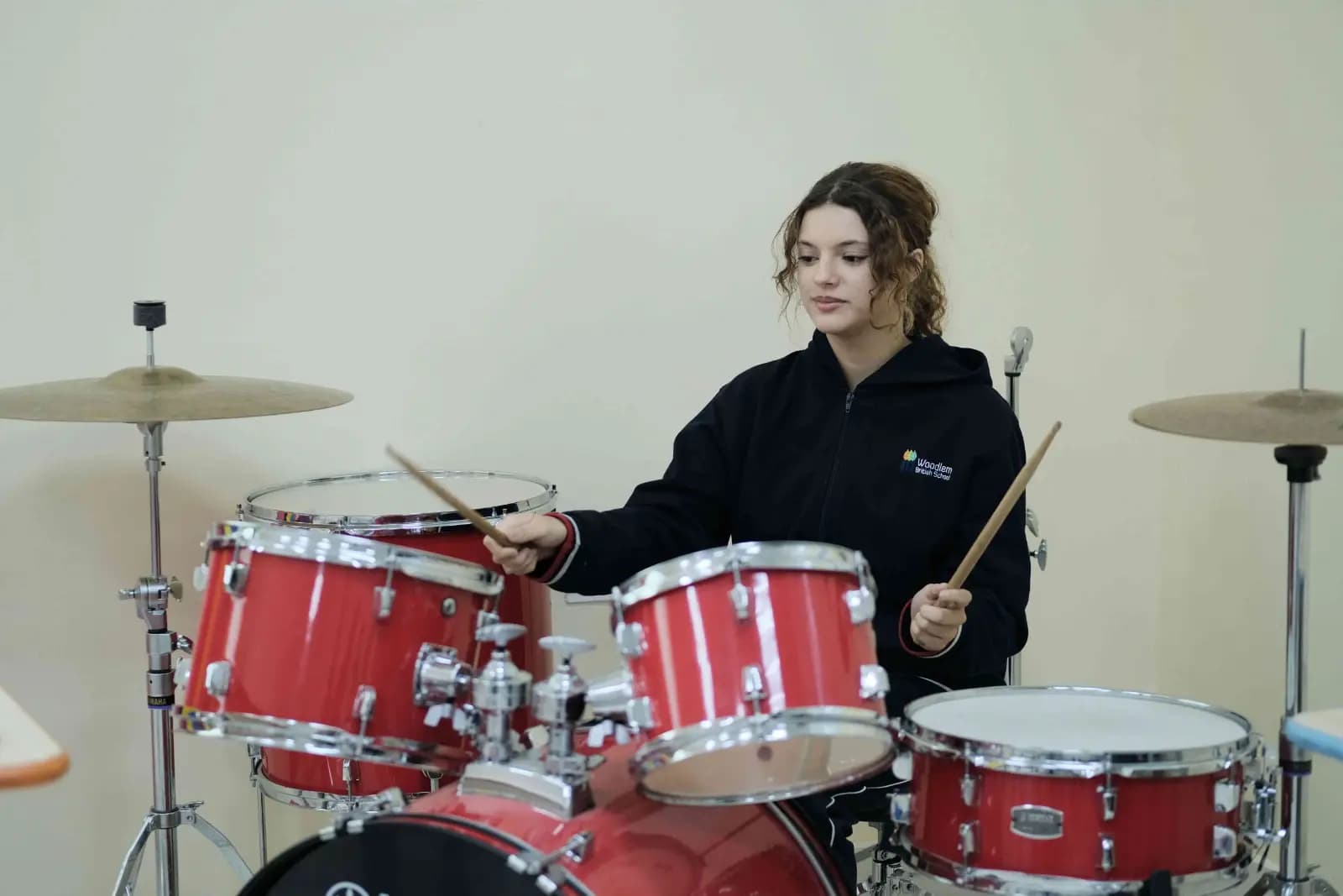 Student on the drum kit in the music studio