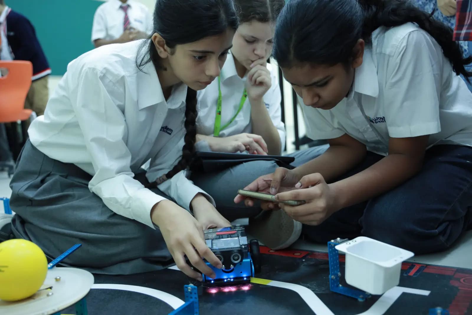 Students programming a robotics kit